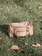 Skylaris Wanderer Duffel in Camel on grass.