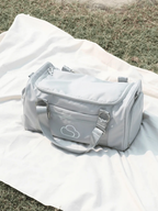 Skylaris Wanderer Duffel in Stone on a white picnic mat outdoors